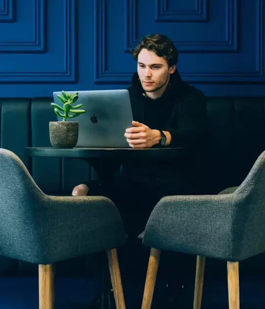 Man looking at laptop, viewing website image